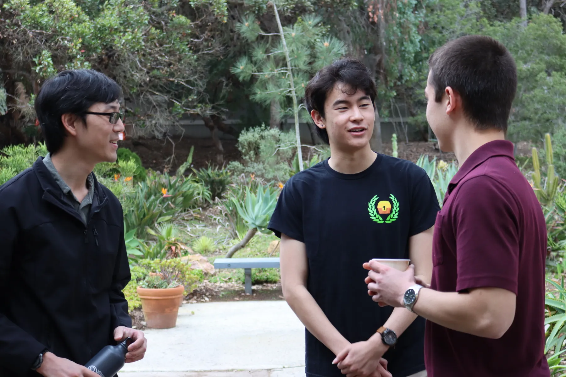 Brandon Joe and Ethan Kosaki welcome a volunteer for the networking portion